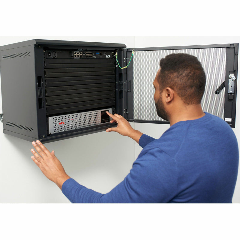 IT professional installing APC Smart-UPS in a server rack