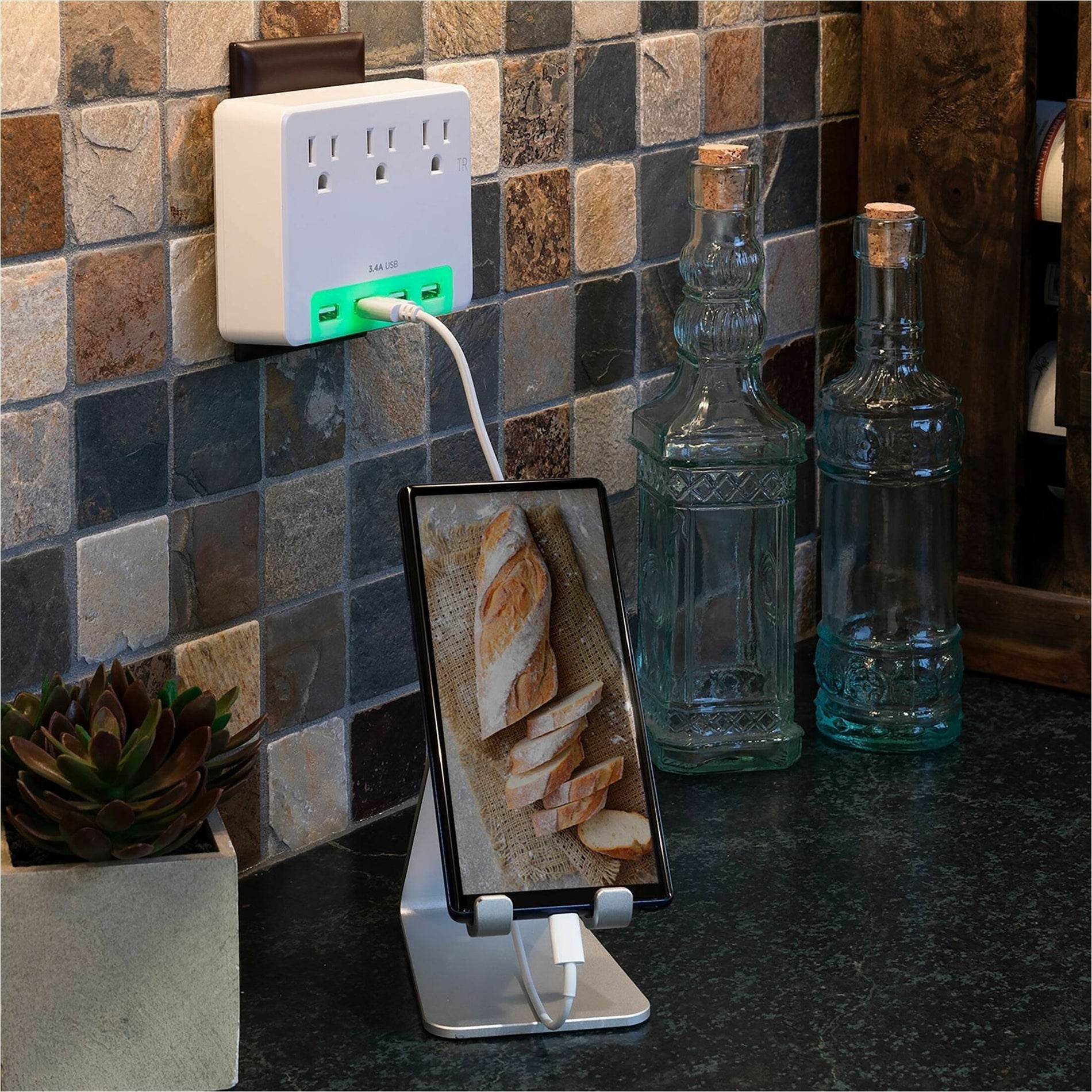 Surge protector mounted on kitchen backsplash with phone charging-alternate-image11