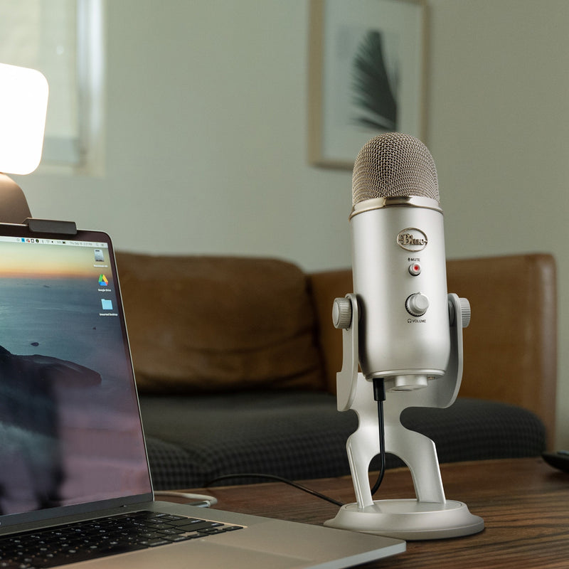 Blue Yeti microphone set up on desk with laptop for home studio recording