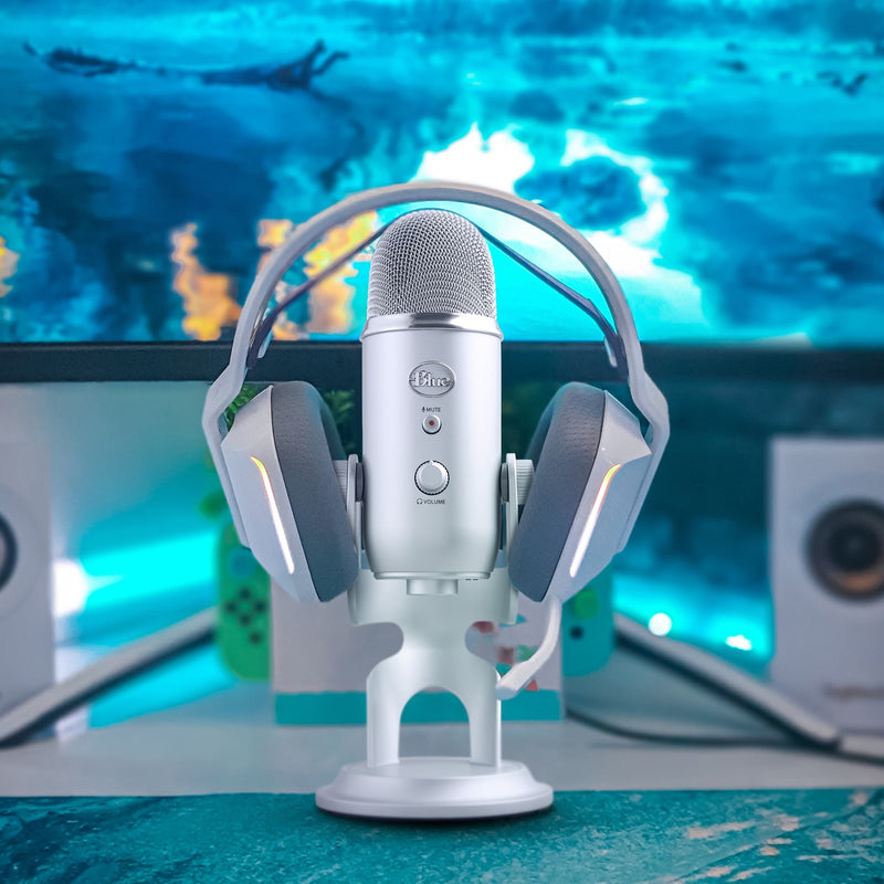 Blue Yeti microphone with gaming headset against blue background