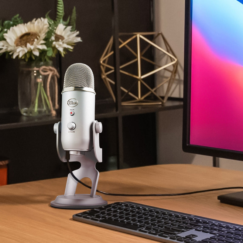 Blue Yeti microphone on wooden desk with aesthetic workspace setup