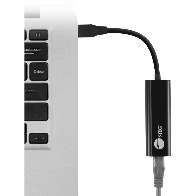 SIIG USB-C to 2.5G Ethernet adapter connected to laptop keyboard showing easy integration