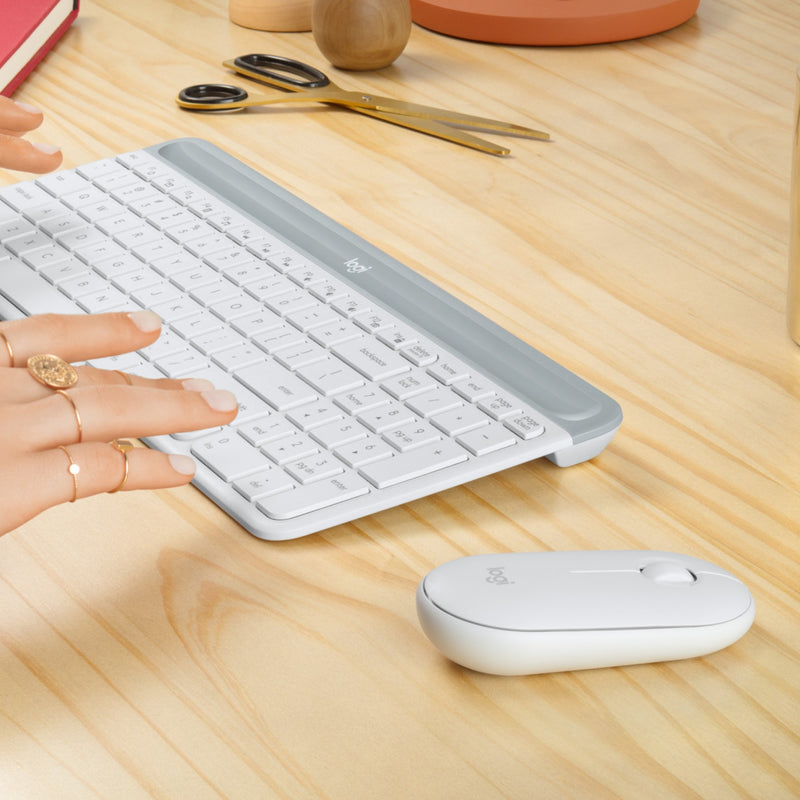 Close-up of hands typing on Logitech MK470 slim keyboard showing ergonomic design