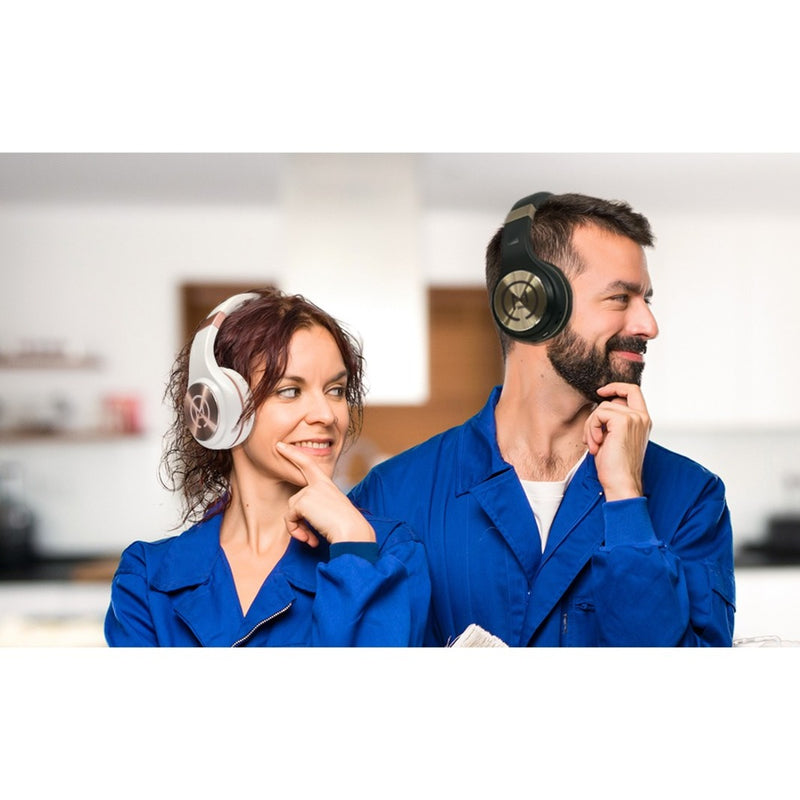 Two professionals wearing Morpheus 360 headphones in a work environment