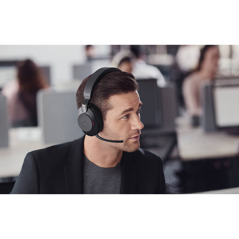 Professional wearing Jabra Evolve2 85 headset in an office environment