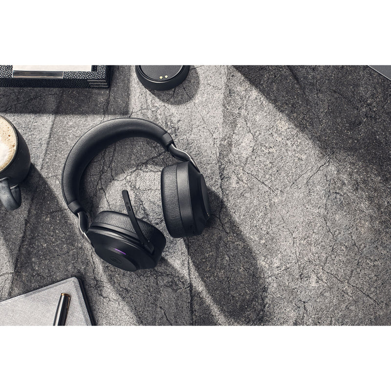 Jabra Evolve2 85 headset on a desk with office accessories