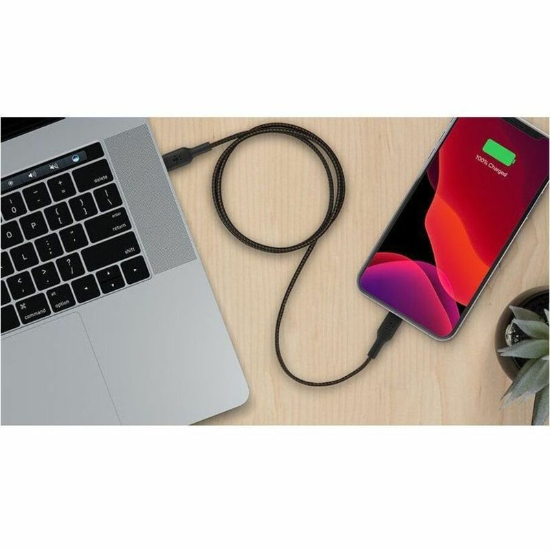 Lifestyle image showing Belkin cable connected between MacBook and iPhone on desk