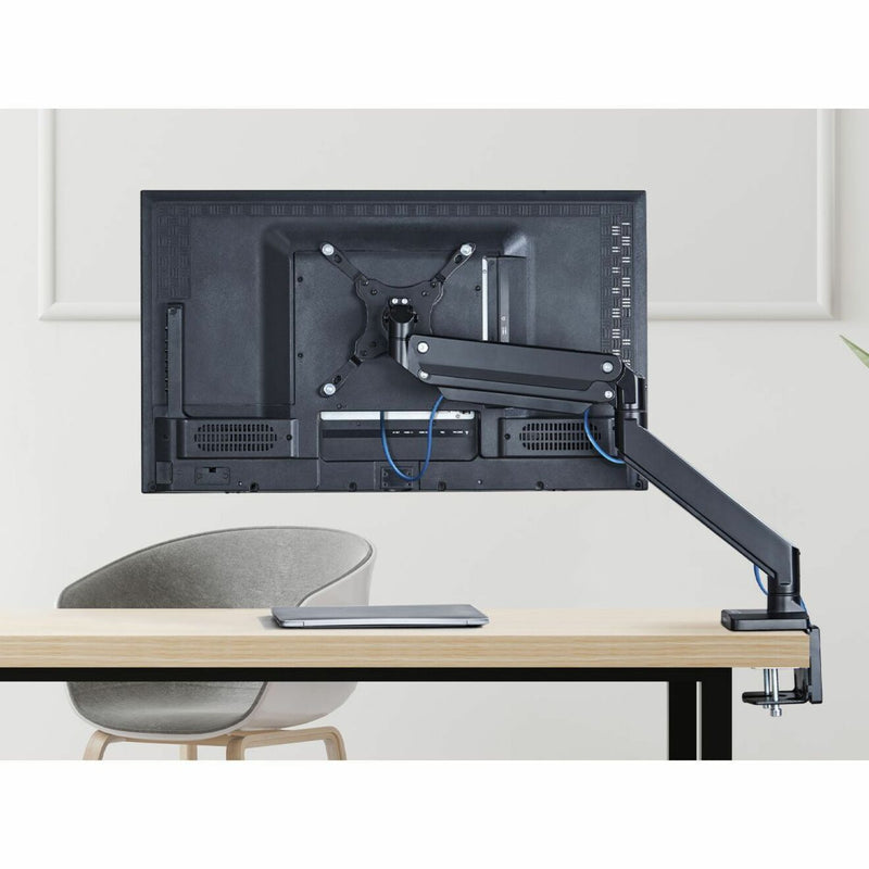 Monitor arm showing integrated cable management system in office setting