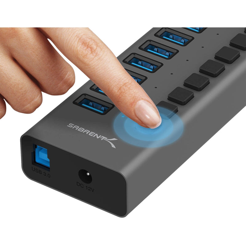 Close-up of finger pressing individual power switch on Sabrent USB hub