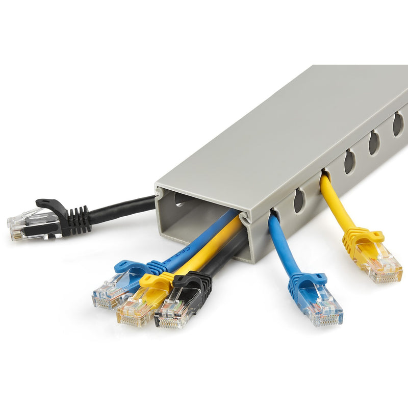 Cable raceway shown with multiple ethernet cables of different colors routed through slots