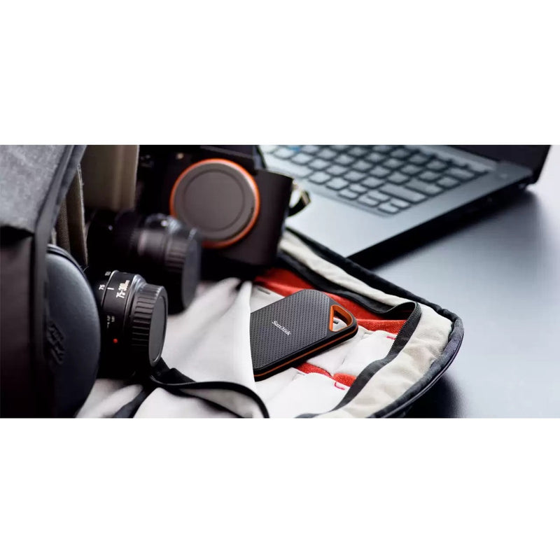 SanDisk Extreme PRO Portable SSD shown with camera equipment and laptop in a creative workspace