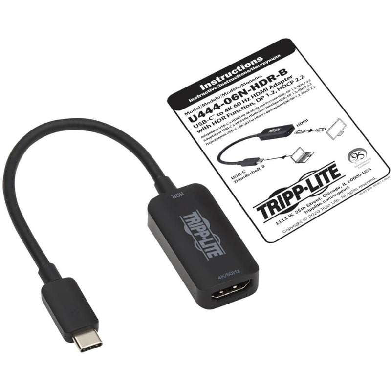 Tripp Lite adapter shown with instruction manual and packaging