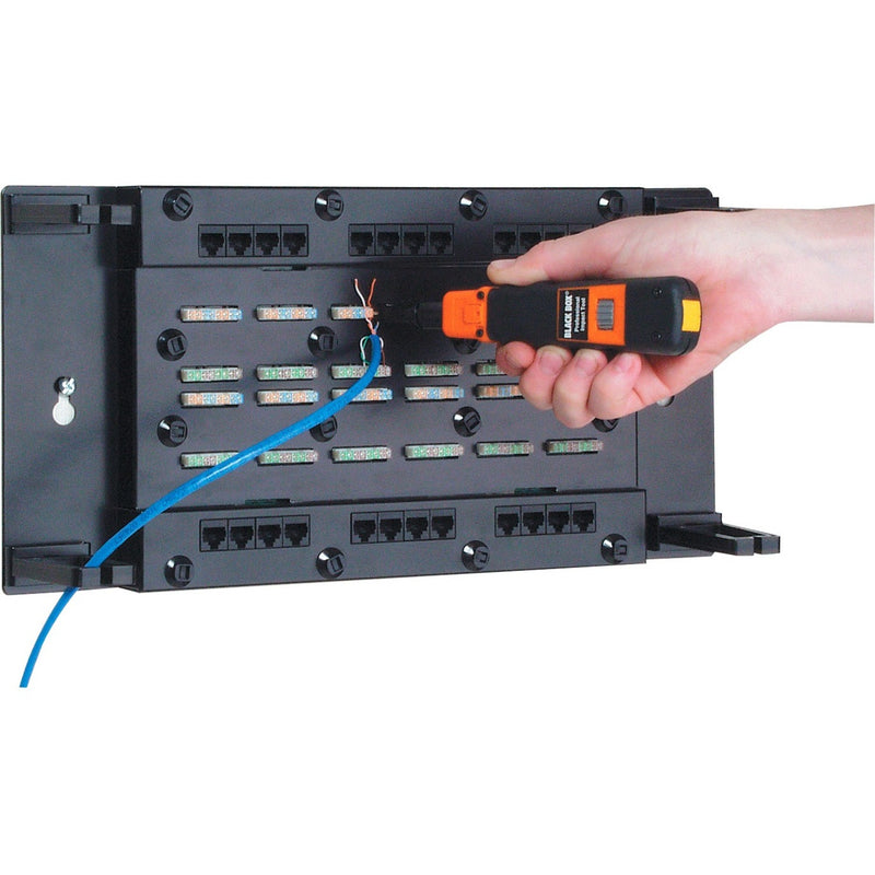 Black Box CAT5e patch panel being tested with an orange and black cable tester, showing internal wiring and punch-down blocks