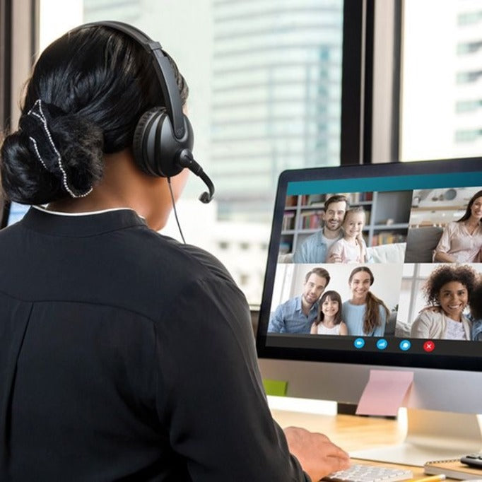 Professional using Aluratek headset during video conference call