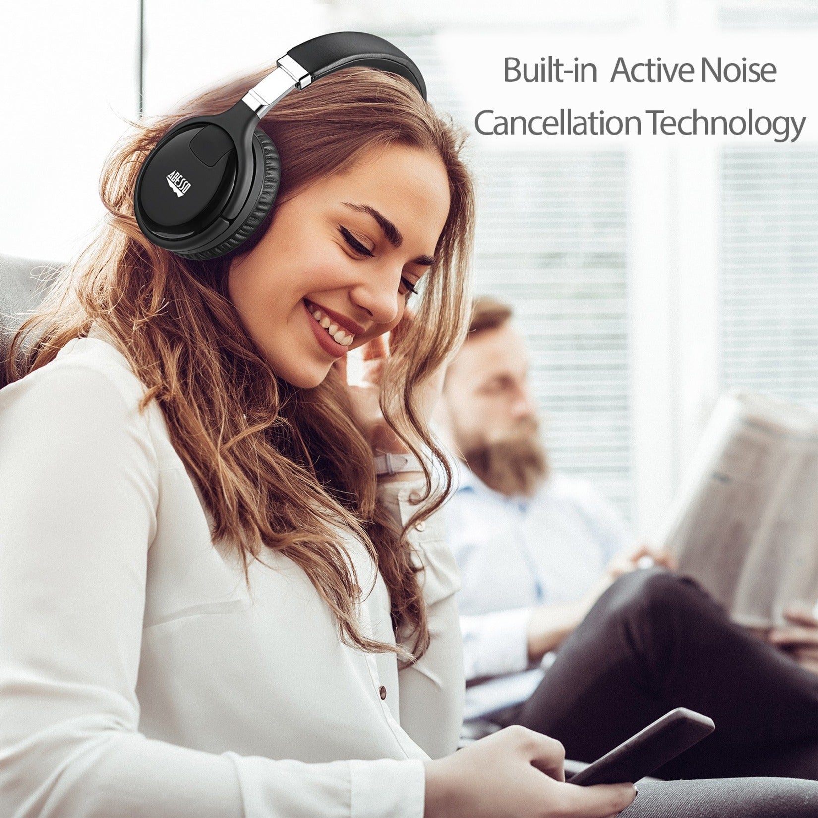 Person enjoying Adesso Xtream P600 headphones with Active Noise Cancellation in office setting-alternate-image9