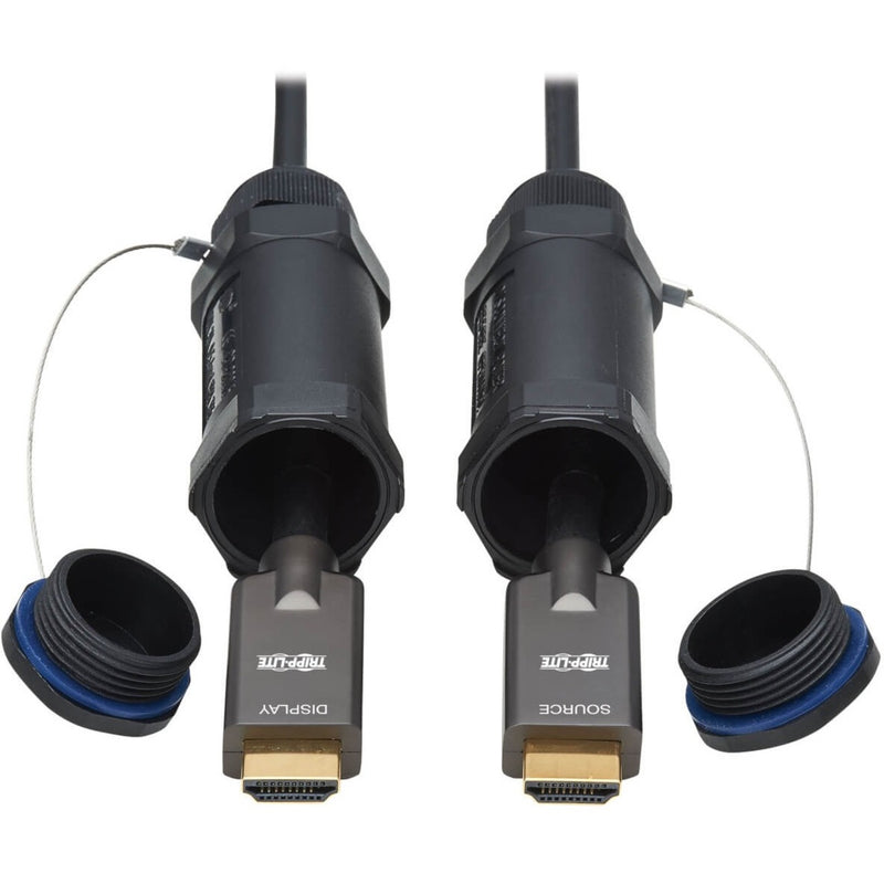 Close-up view of gold-plated HDMI 2.0 connectors with protective caps on Tripp Lite fiber optic cable