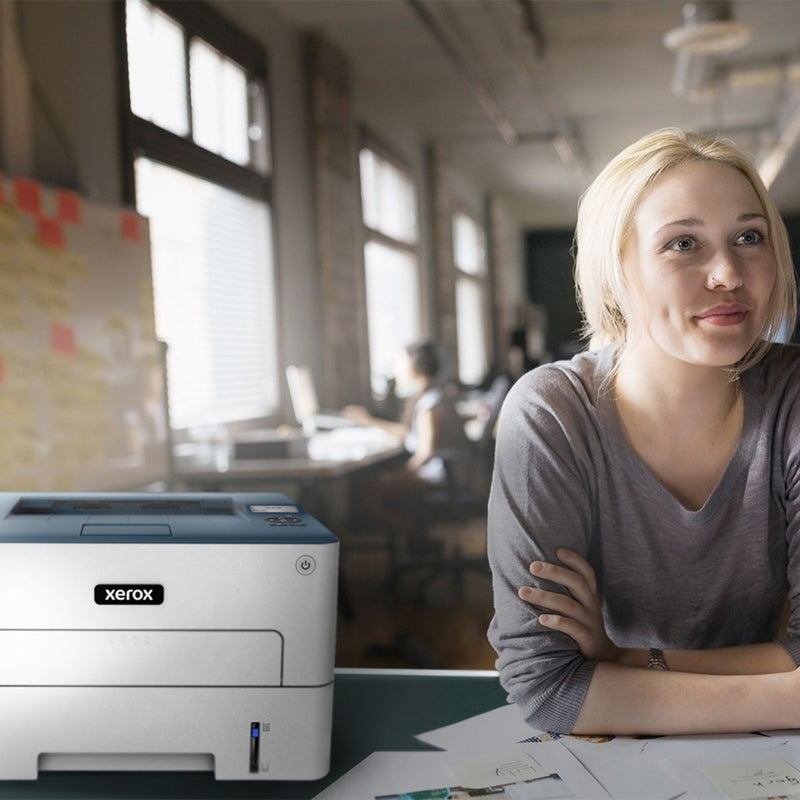 Xerox B230 printer in a modern office setting with remote work setup