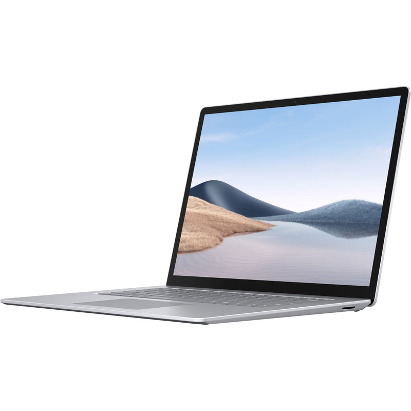 Surface Laptop 4 shown from side angle in platinum color with display showing scenic wallpaper