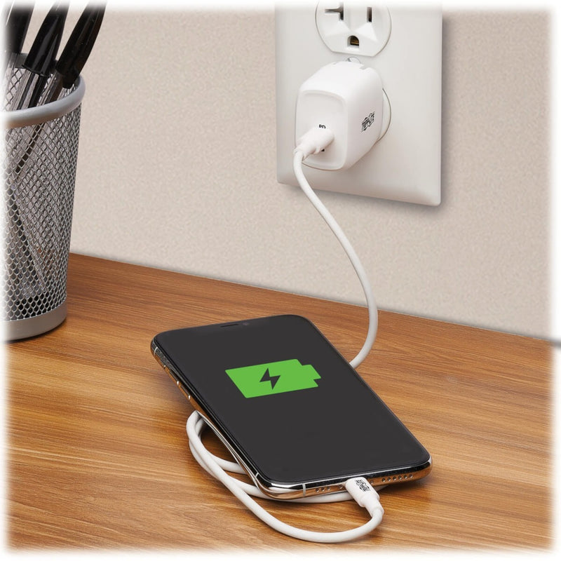 Tripp Lite charger in use charging a smartphone on a desk