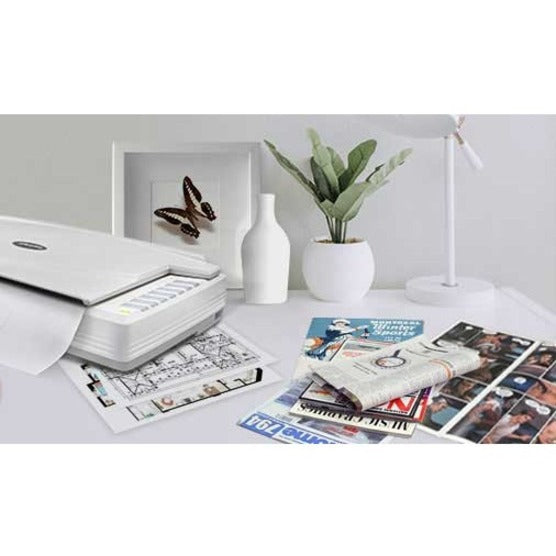 Lifestyle image of scanner with various scanned materials including photos and documents in a clean office setting