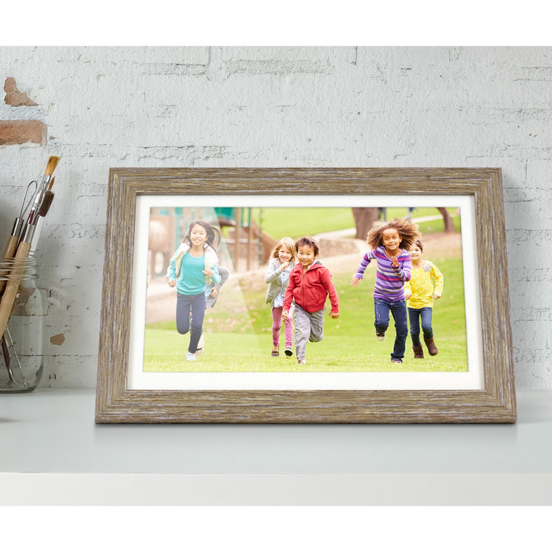 Digital photo frame mounted on white wall displaying vibrant photo