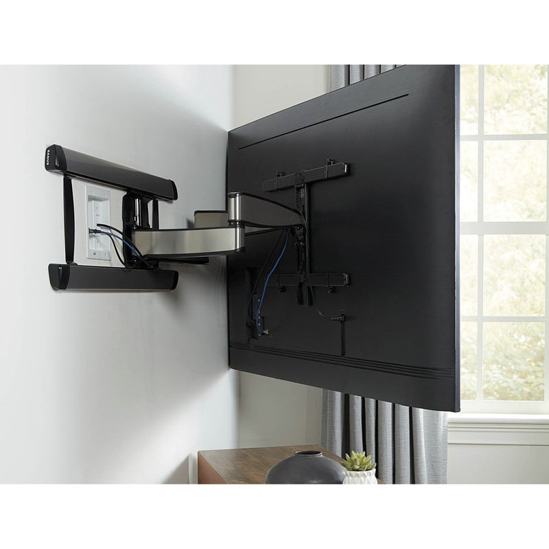 Wall-mounted TV with SANUS power kit installed showing clean cable management with full-motion mount