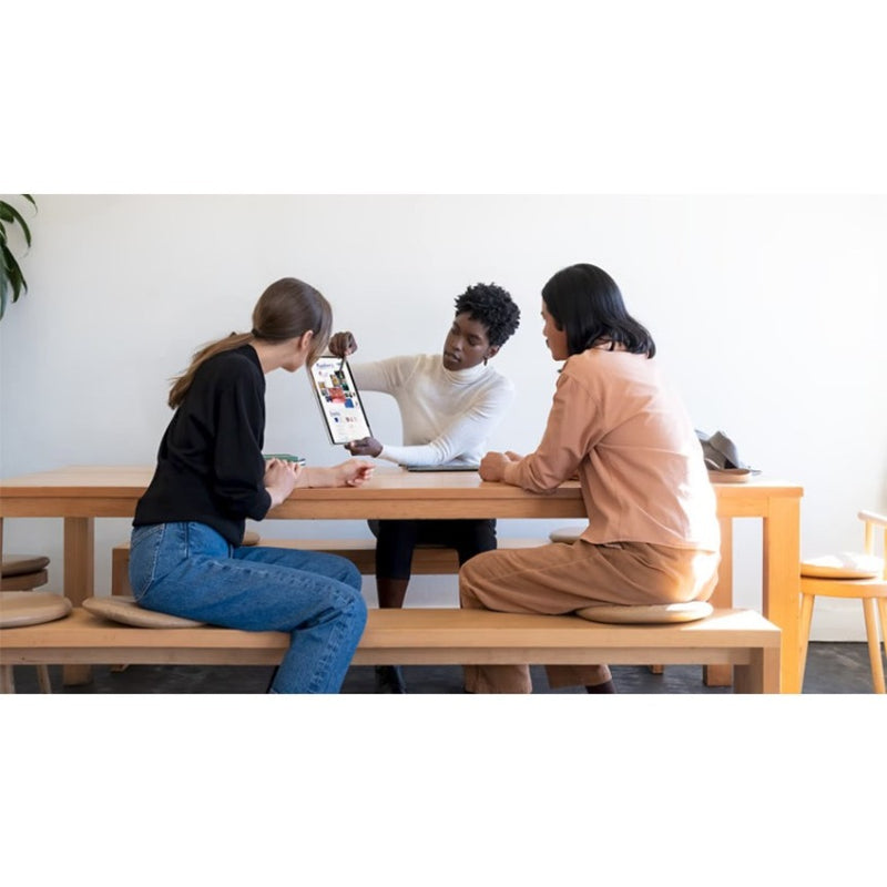 Team members collaborating using Surface devices and Surface Slim Pen 2