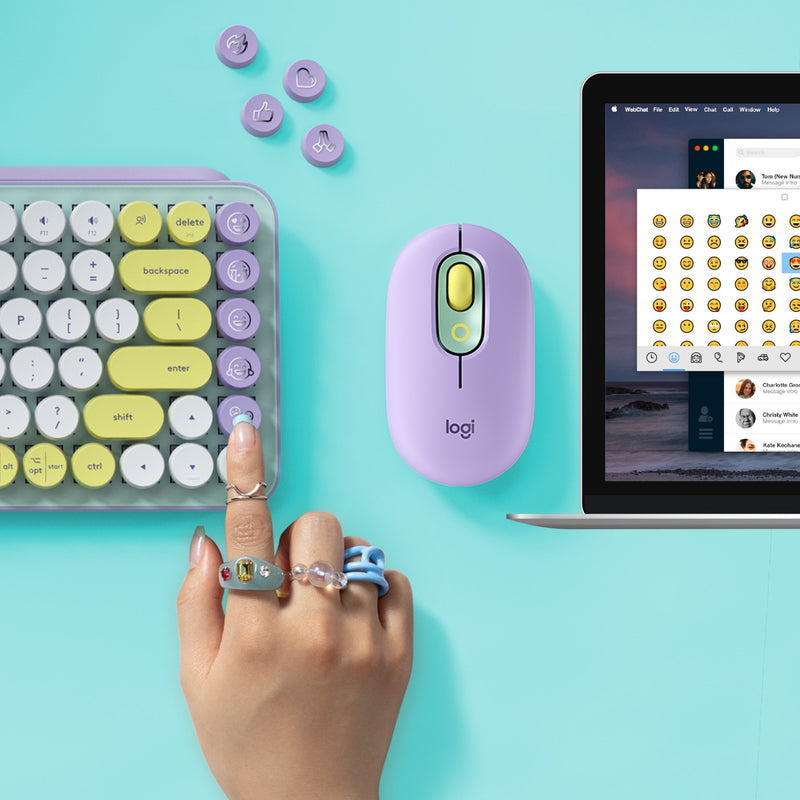 Lifestyle shot of POP Keys keyboard with matching mouse and laptop showing emoji menu interface