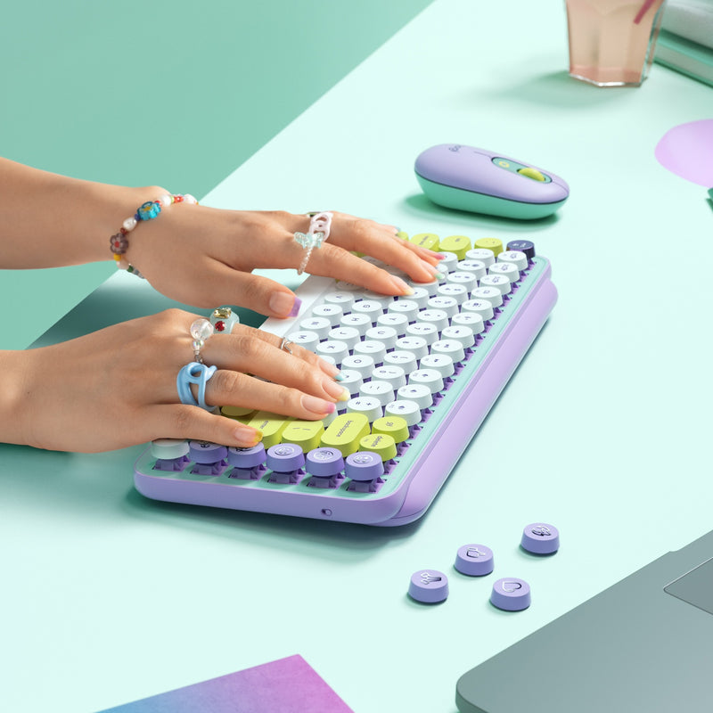 Close-up of hands typing on POP Keys keyboard showing ergonomic key design