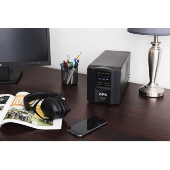 APC Smart-UPS 750VA shown protecting various electronic devices in a modern office setting-alternate-image4