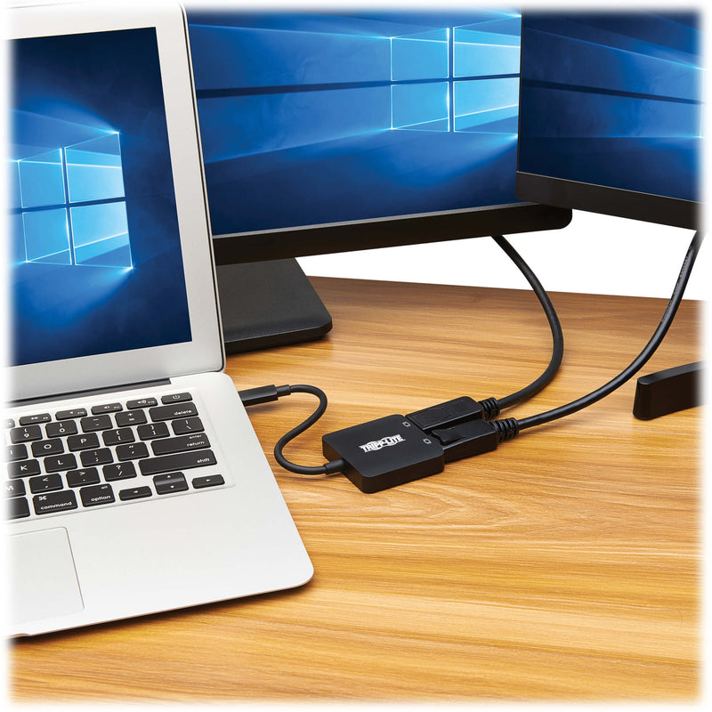 Laptop connected to multiple displays using Tripp Lite adapter in office setting