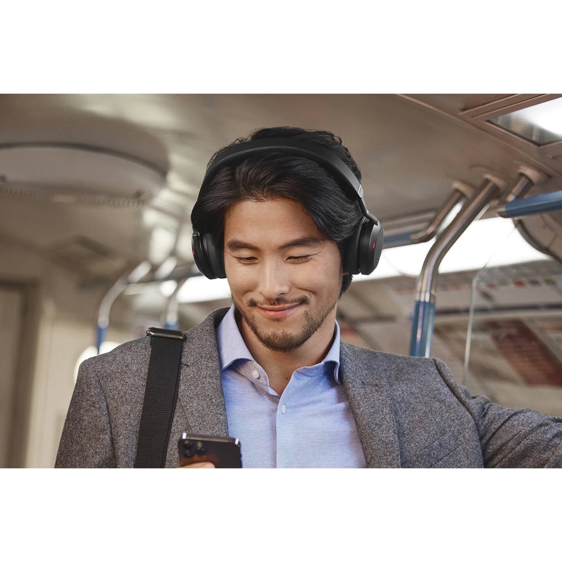 Close-up of professional using Jabra Evolve2 75 with mobile device-alternate-image13