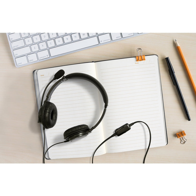 Kensington headset on desk with keyboard and notebook