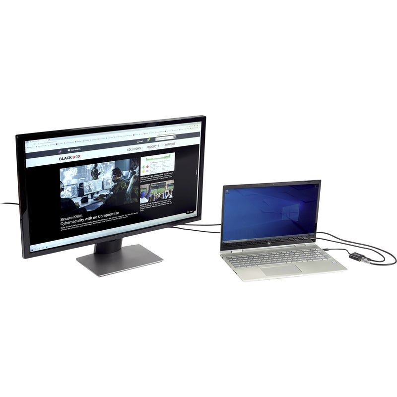 Black Box Ethernet adapter connecting a laptop to a monitor in a professional desktop setup