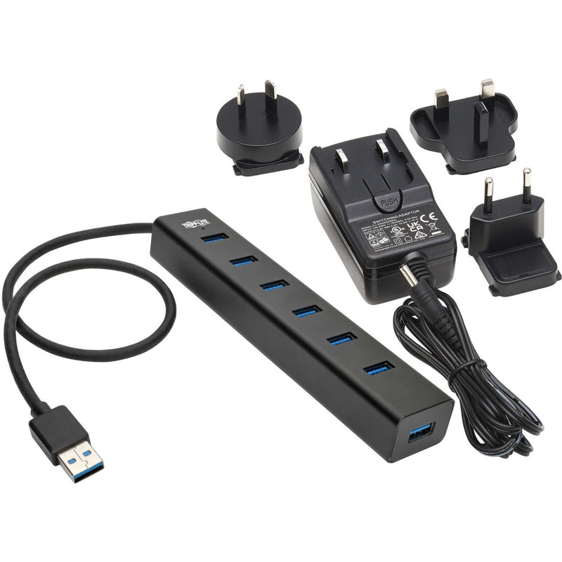 Full package contents showing USB hub, power supply, and international adapters