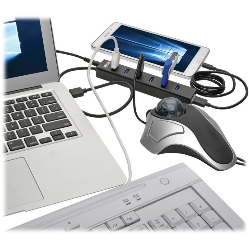 USB hub connected to laptop with multiple peripherals including keyboard, mouse, and mobile device