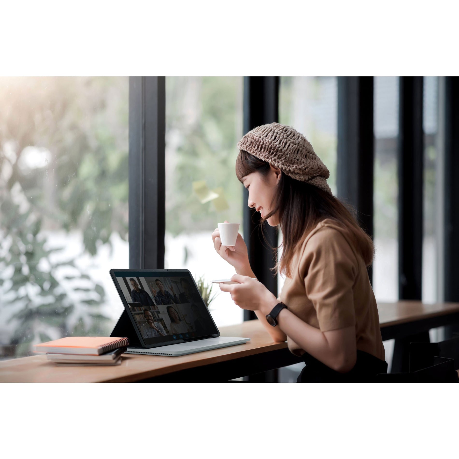 Professional using Surface Laptop Studio with privacy screen in a cafe setting-alternate-image7