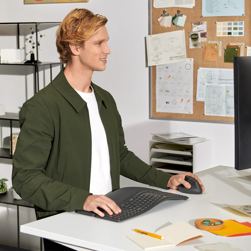 Person using Logitech Lift Left Vertical Mouse in professional office setting