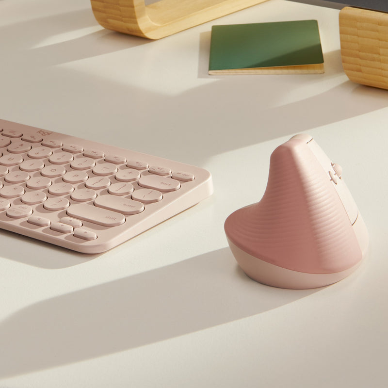 Logitech Lift mouse with matching rose keyboard in minimal workspace setting