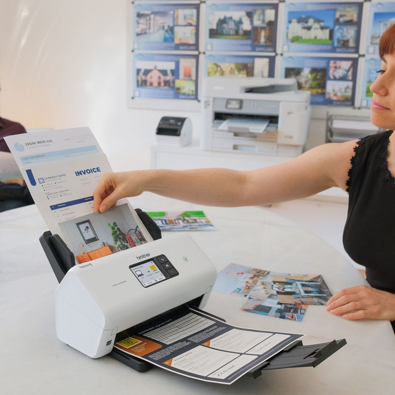 Person using Brother ADS-3300W scanner in office environment