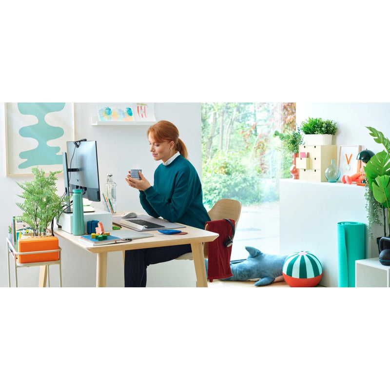 Person using Logitech M650 mouse in a home office environment