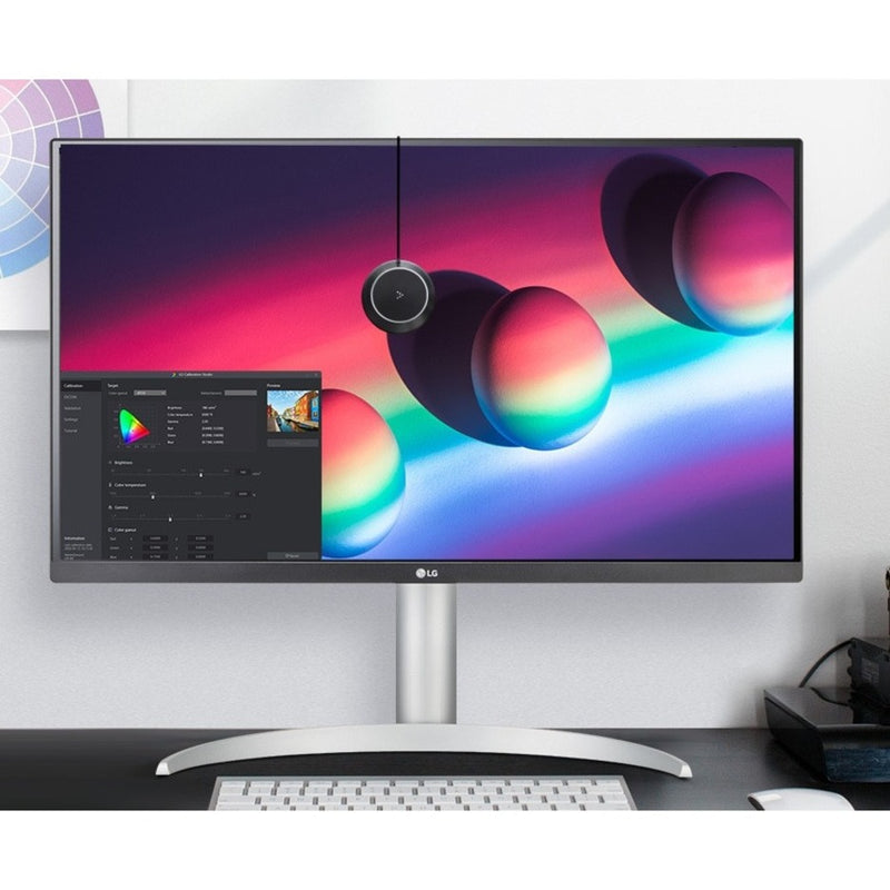 LG monitor displaying color calibration interface with vibrant color spheres