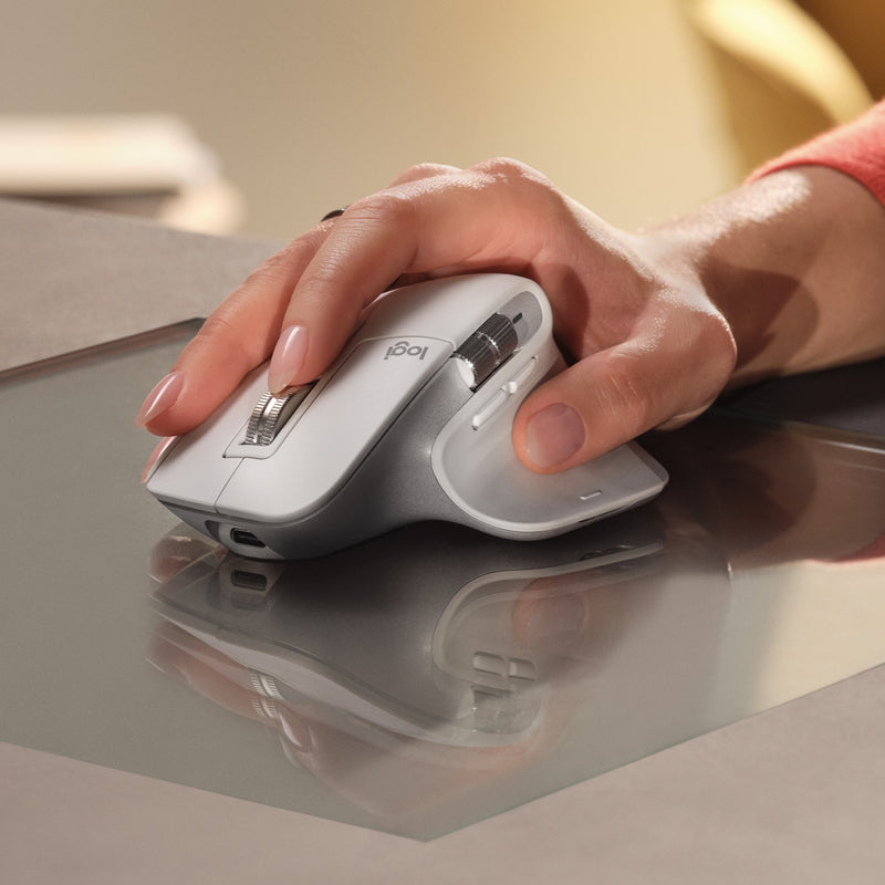 Close-up of white MX Master 3S being used on a desk surface, highlighting quiet click feature