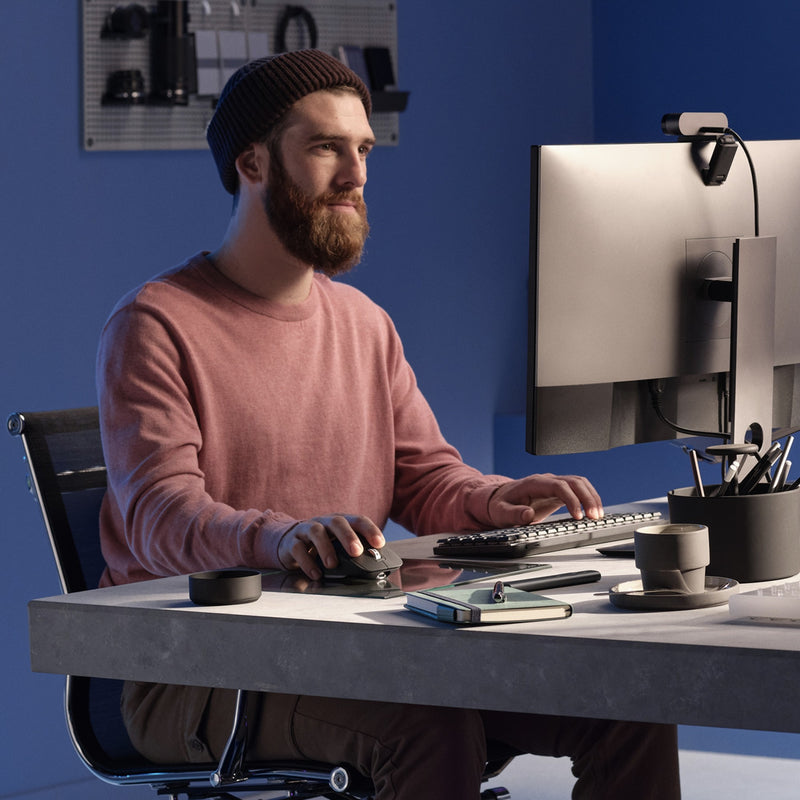 Professional workspace setup showing MX Master 3S mouse in use with multiple displays