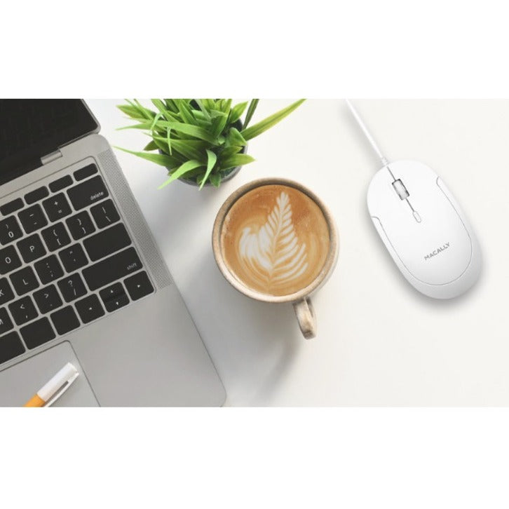 Lifestyle image of Macally mouse on desk with laptop, coffee cup, and plant