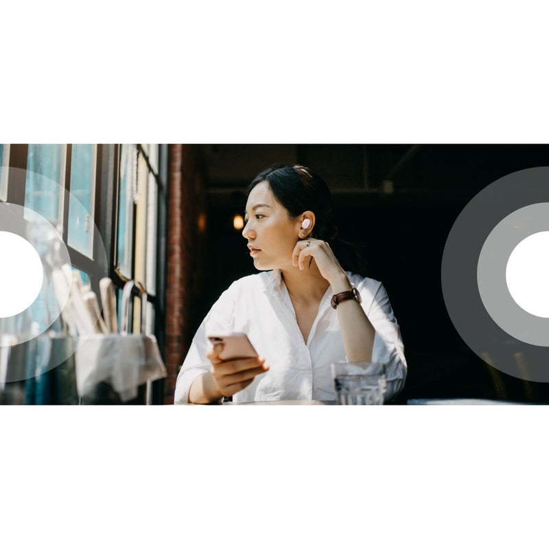 Person using Belkin earbuds while working at a cafe