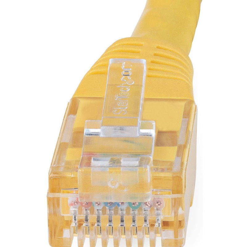 Macro shot of Cat6 cable connector showing detailed pin arrangement and transparent housing with StarTech.com branding