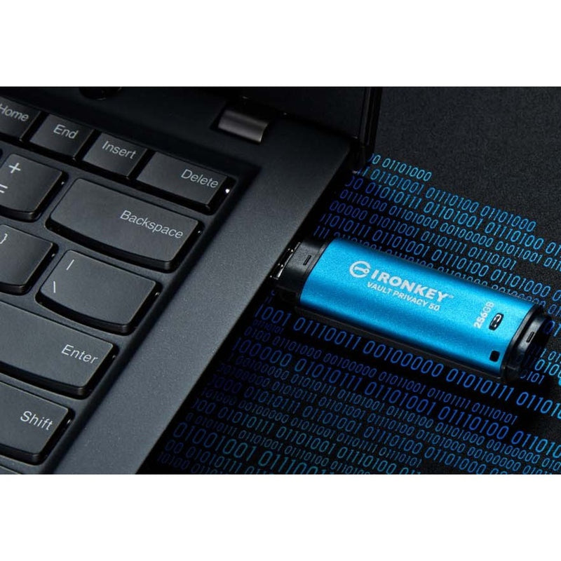 IronKey USB drive against digital binary code background with laptop keyboard