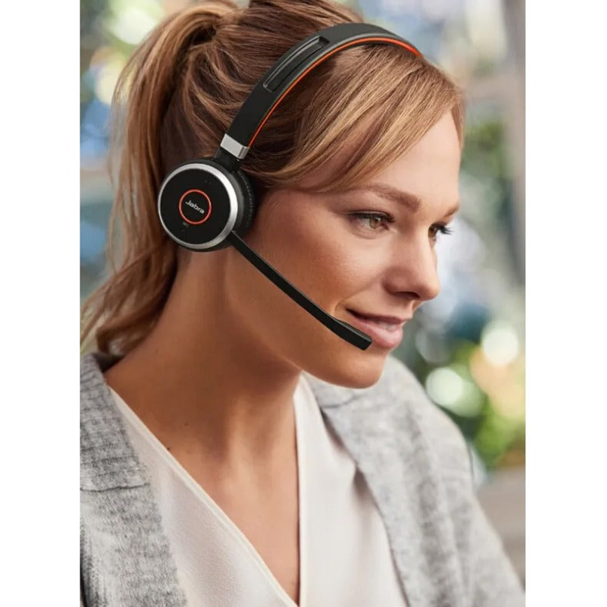 Professional wearing Jabra Evolve 65 headset in an office setting, demonstrating comfort and fit-alternate-image4