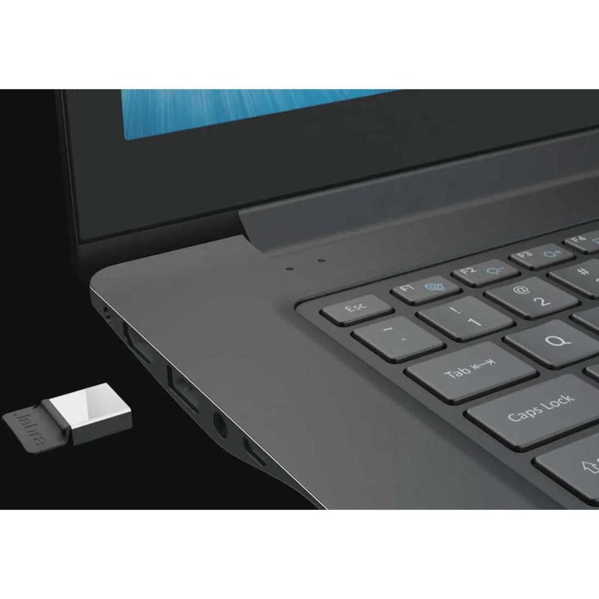 Close-up of Jabra Link 380 USB adapter next to laptop keyboard-alternate-image5